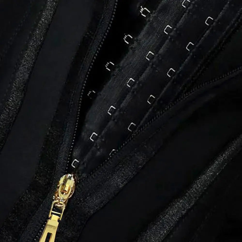 Close-up of a black jacket with a gold zipper on a dark background